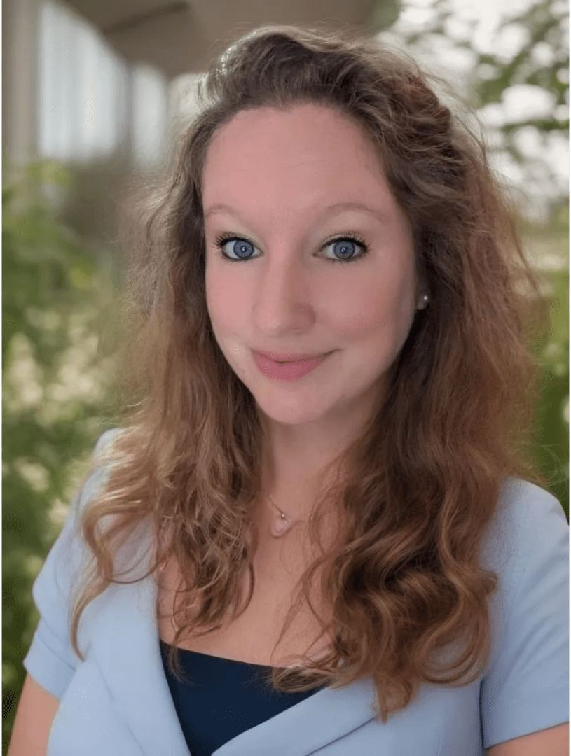 A woman with long hair and blue eyes.